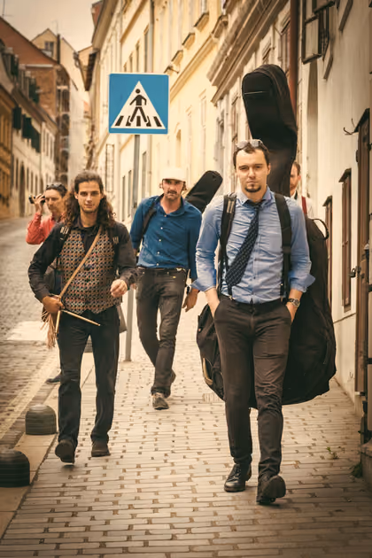 The band walking down a Zagreb street with their instruments