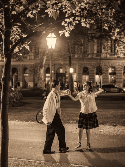 Two dancers under a street lamp, black-and-white photo
