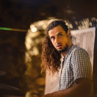 The drummer at his kit in the evening
