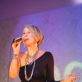The singer at a corporate event, purple light